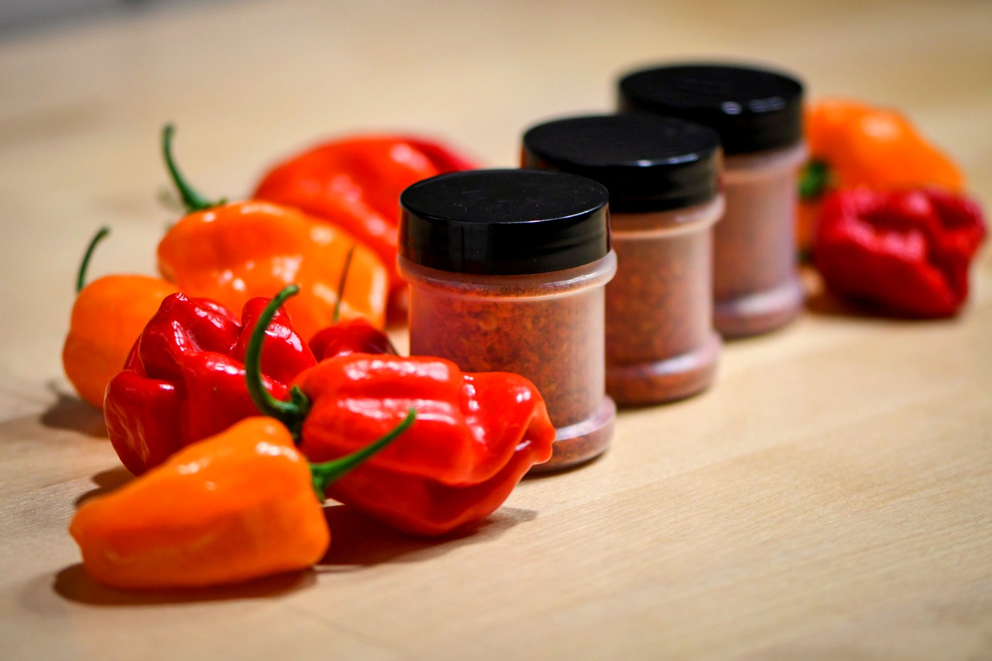 Snake Oil Spices jars with fresh habaneros