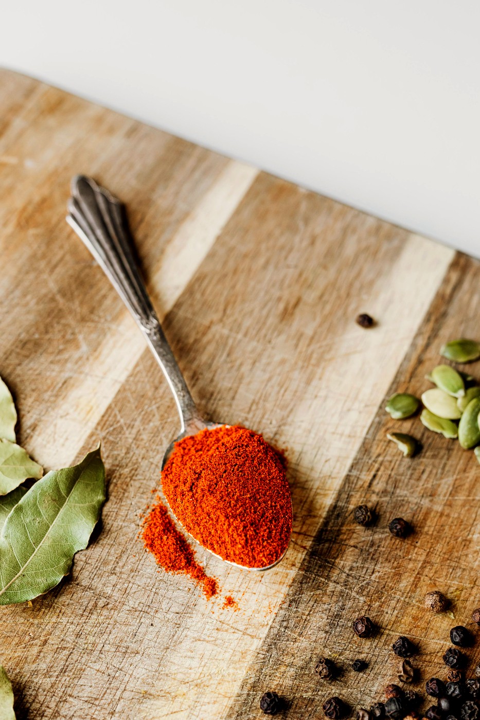 A spoonful of paprika on a cutting board