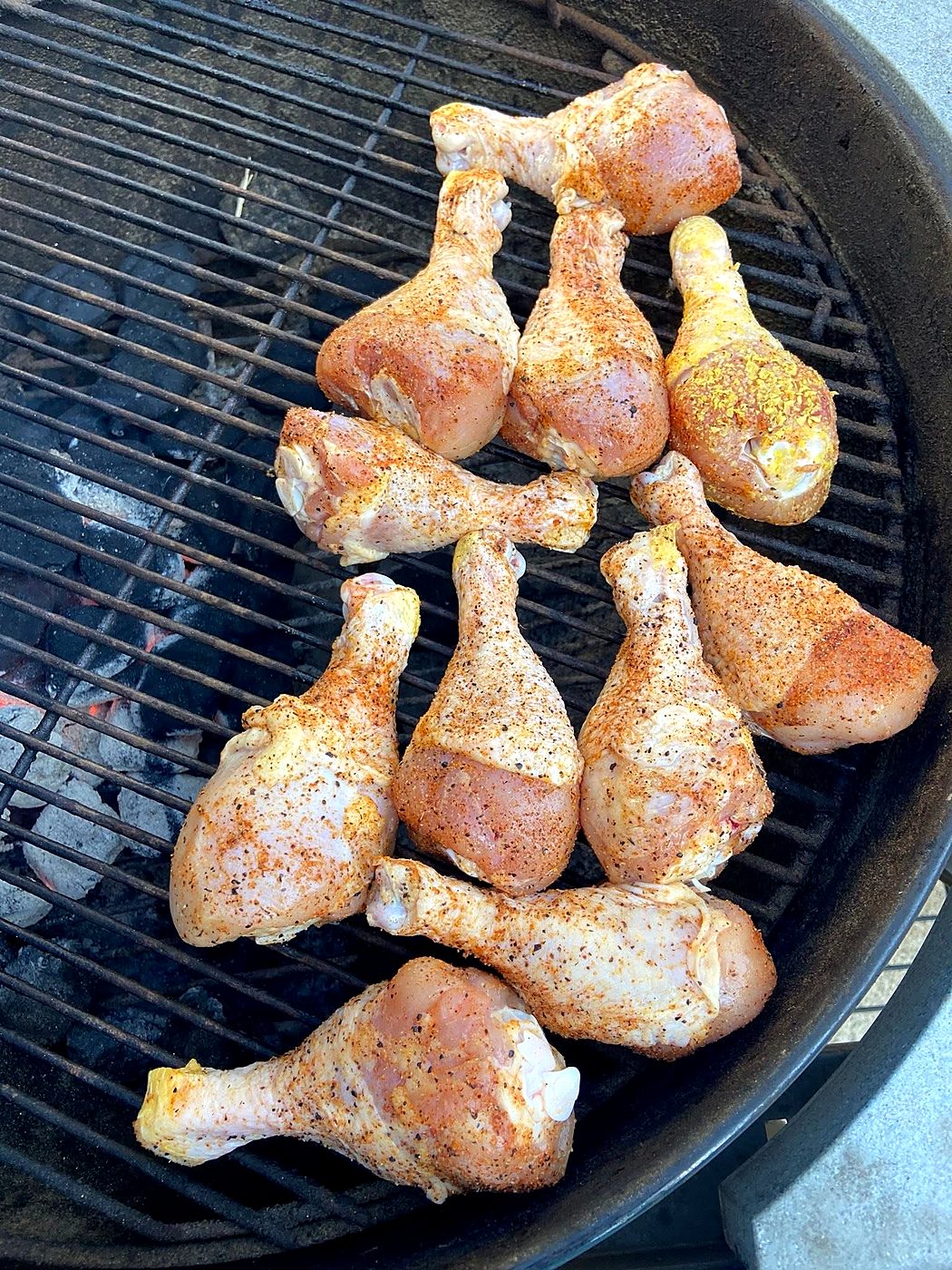 Seasoned drumsticks over charcoal