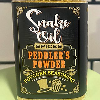 A bottle of Peddler's Powder popcorn seasoning